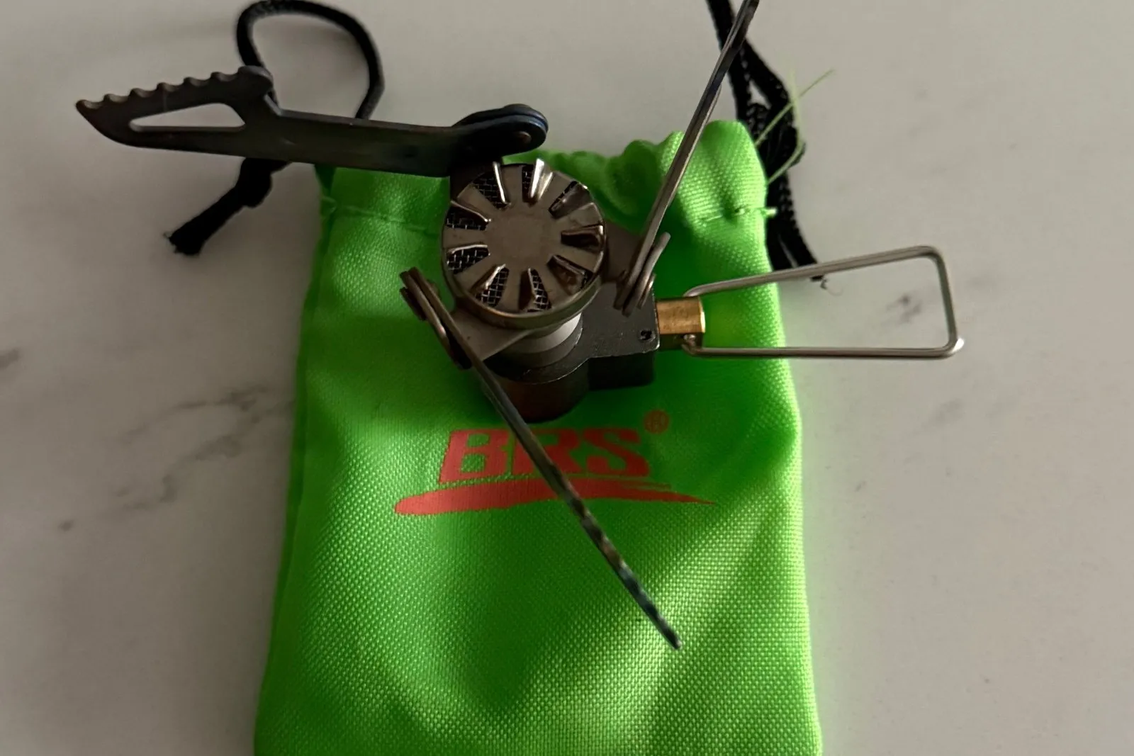 The folded-up BRS-3000T stove sitting on its green BRS stuff sack