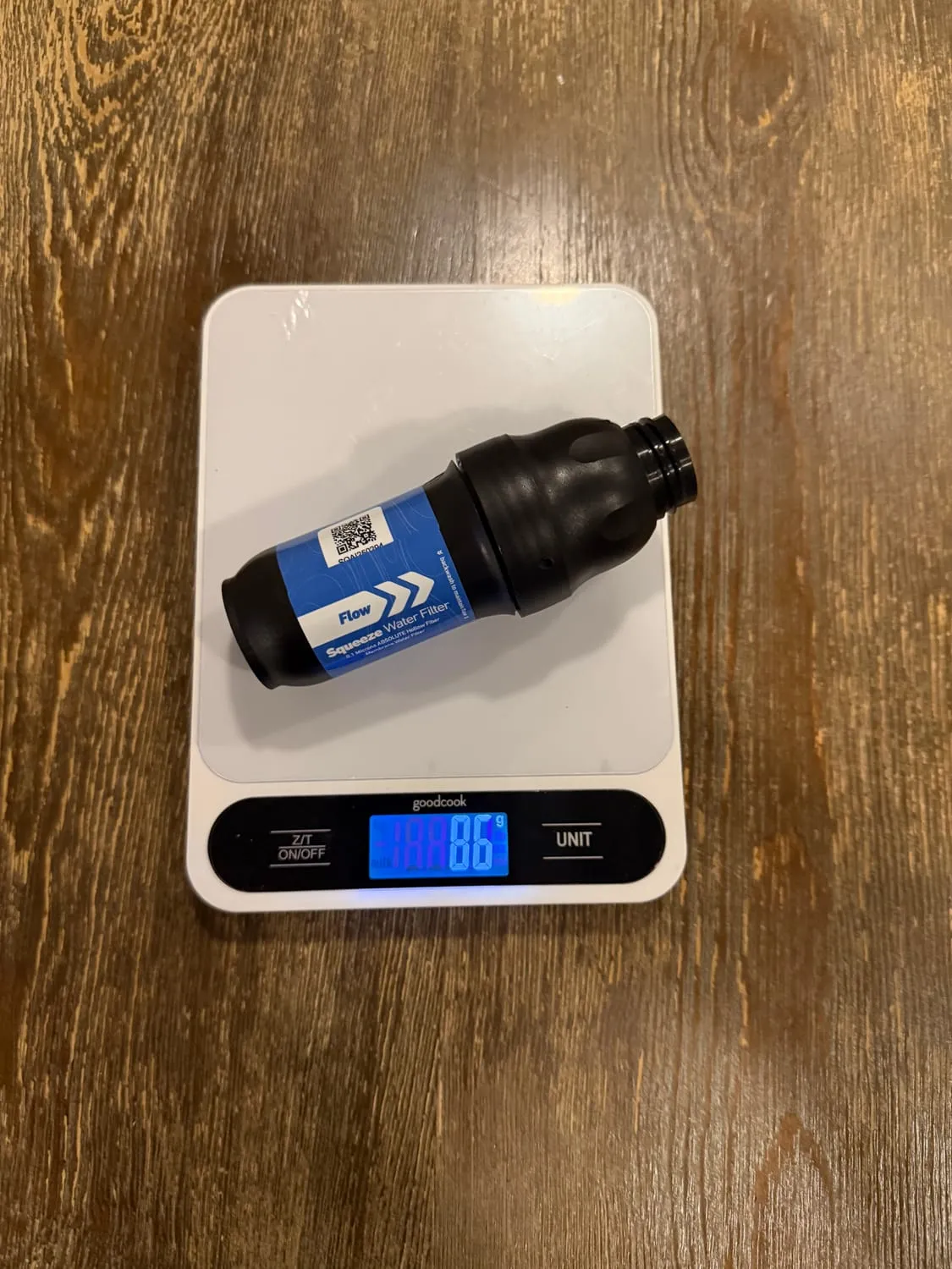 The Sawyer Squeeze, fully dry, on a kitchen scale reading 86 grams