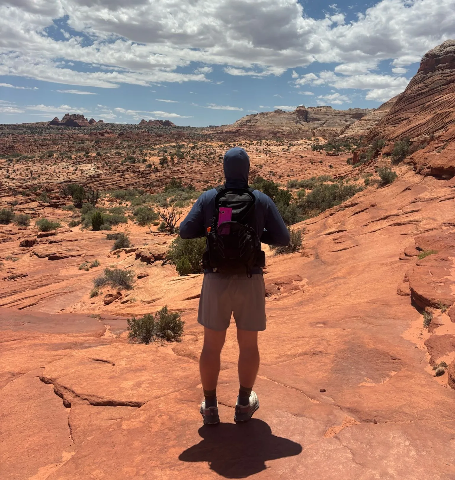 Wearing the Osprey Talon 26 on red slickrock in the desert