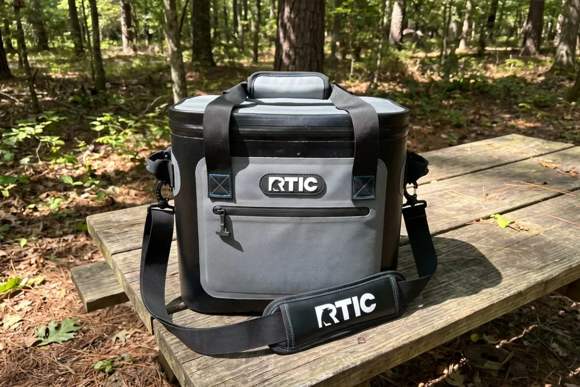 My RTIC 30 can soft cooler on a picnic table at a wooded campsite